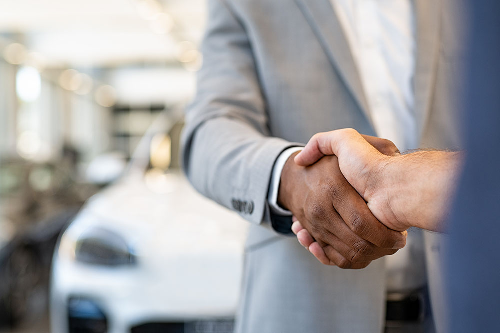 Closeup of a salesperson shaking hands with client